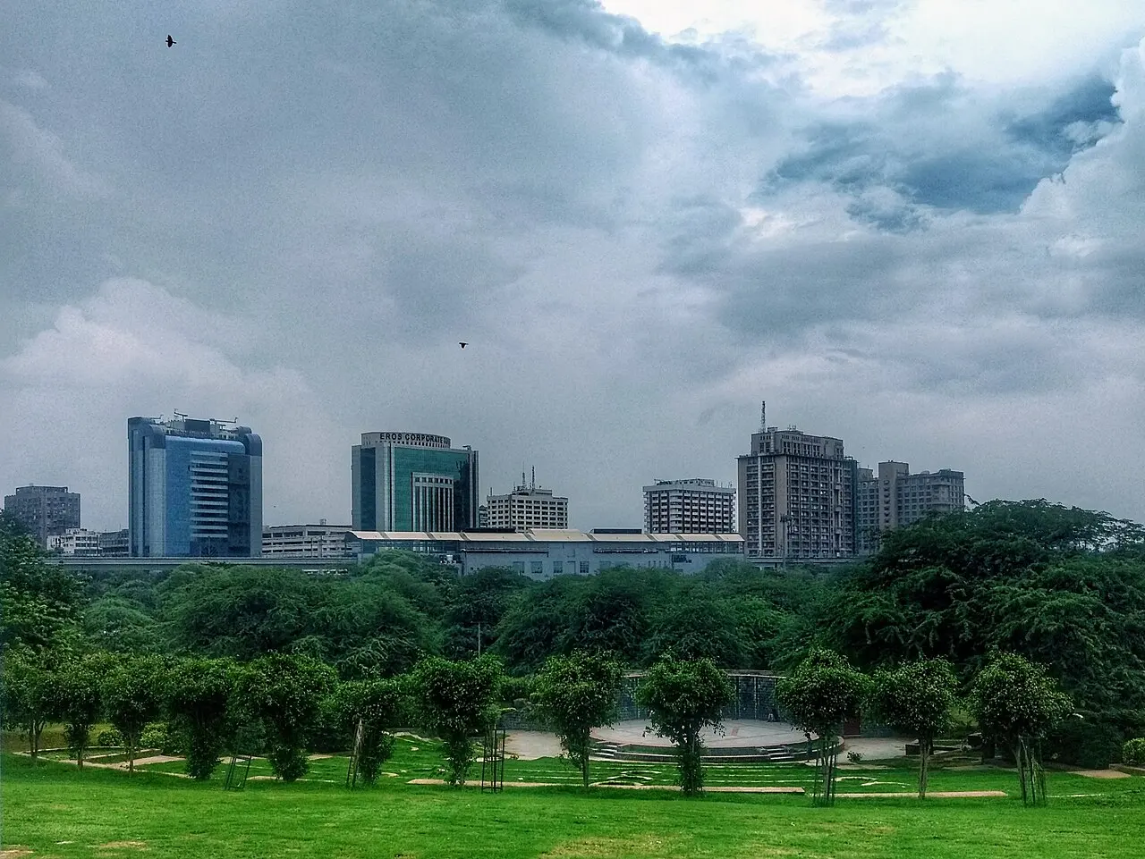 Nehru Place skyline in Delhi beneath a cloudy sky